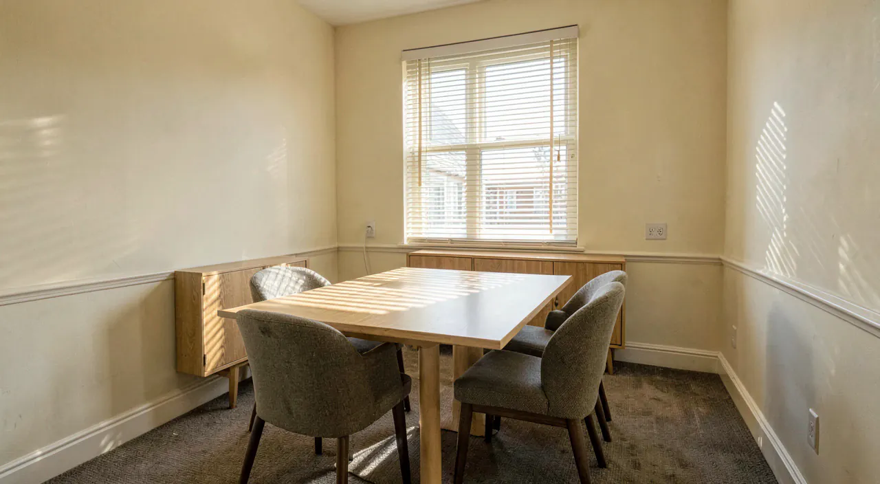 The empty meeting room at Paperbark Lane, long table, two chairs and venetian blinds